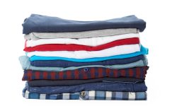 Stack of clothes on white background, closeup